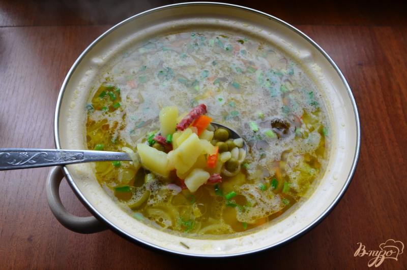 Фото приготовление рецепта: Куриный суп с колбасой, макаронами и консервированным горошком шаг №6