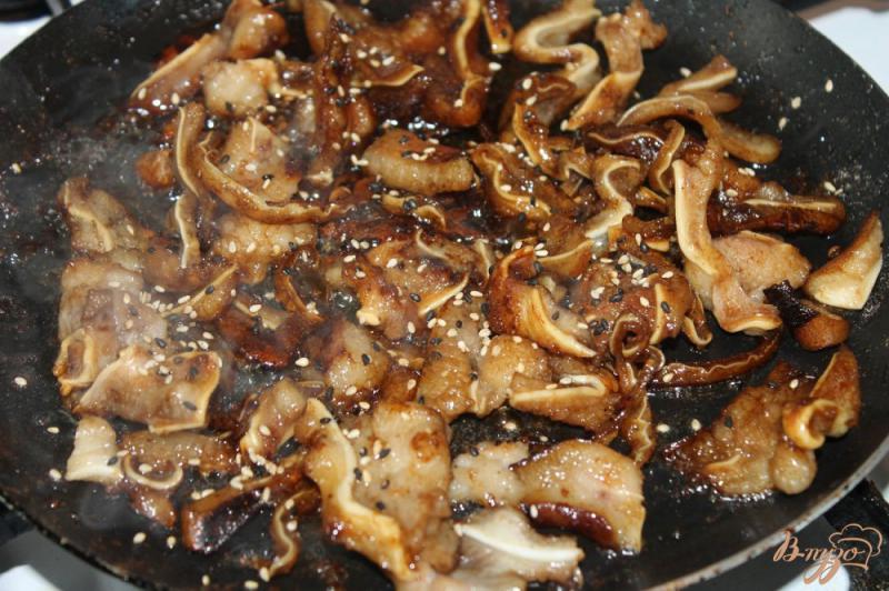 Фото приготовление рецепта: Свиные ушки жаренные в соевом соусе с кунжутом шаг №5