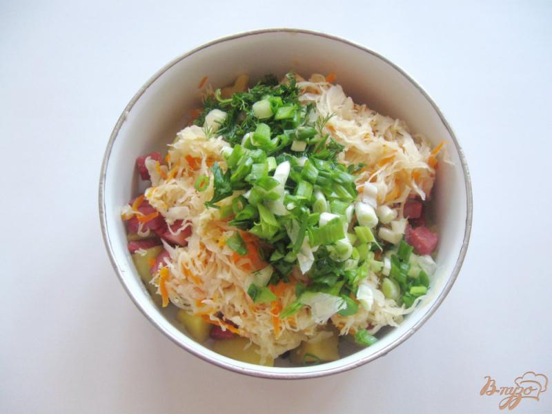 Фото приготовление рецепта: Теплый салат с квашеной капустой и копченой колбасой шаг №7
