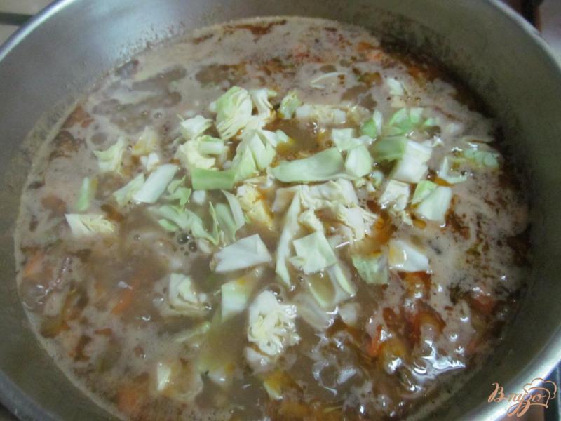 Фото приготовление рецепта: Густой суп из капусты с фаршем и пшеном шаг №7