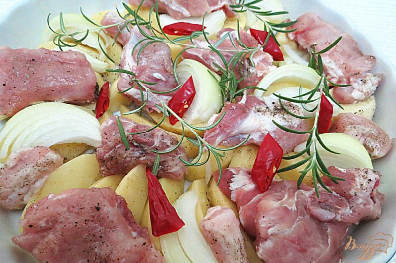 Фото приготовление рецепта: Свиные рёбрышки с картофелем и розмарином, запеченные шаг №5