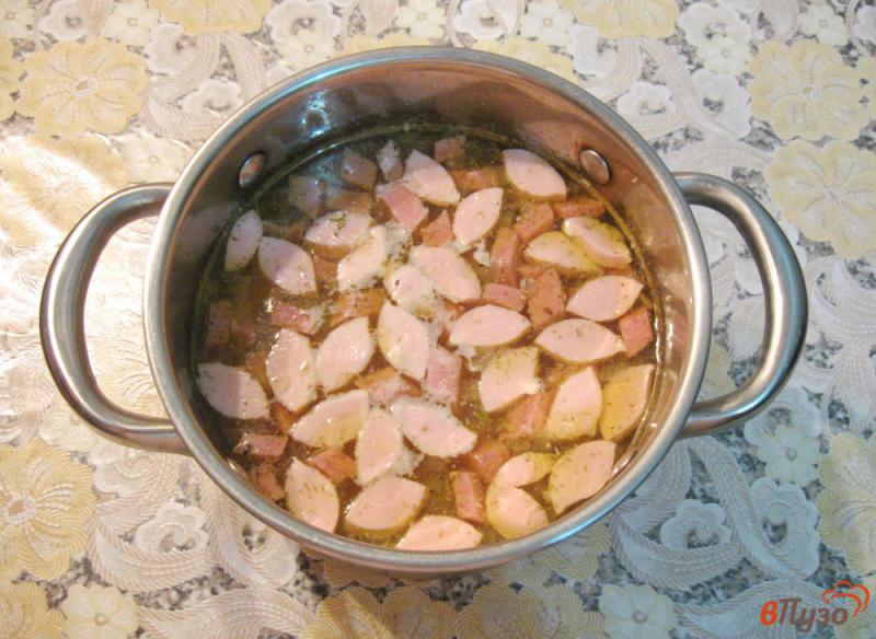 Фото приготовление рецепта: Пшенный суп с копченой колбасой и сосисками шаг №7