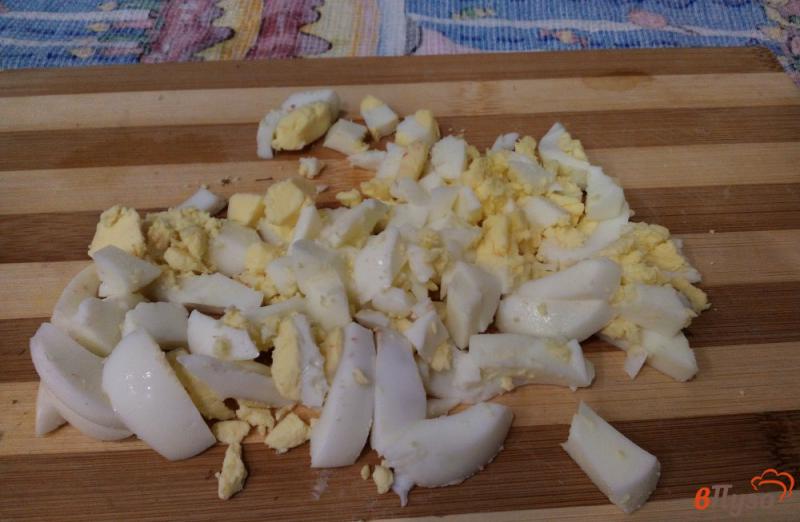 Фото приготовление рецепта: Салат с крабовыми палочками, рисом и яйцами шаг №4