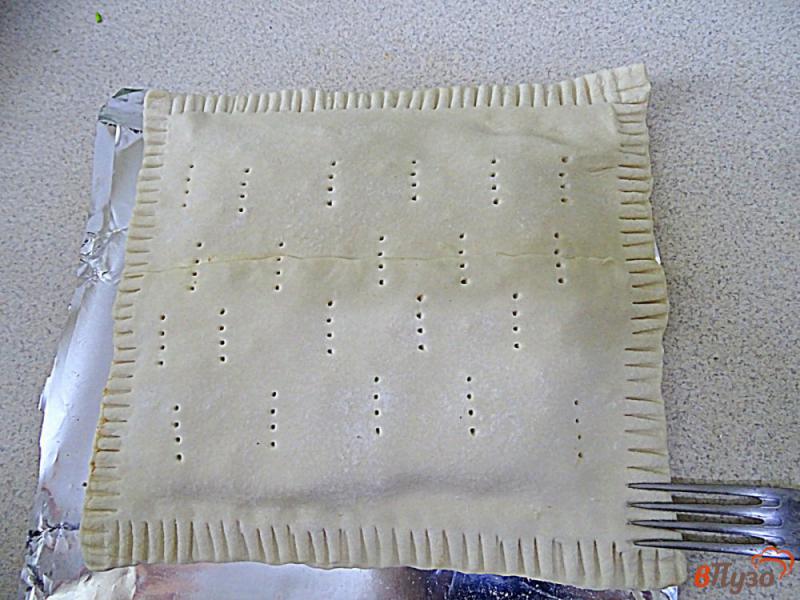 Фото приготовление рецепта: Слоёный пирог с консервированной килькой в томате шаг №9