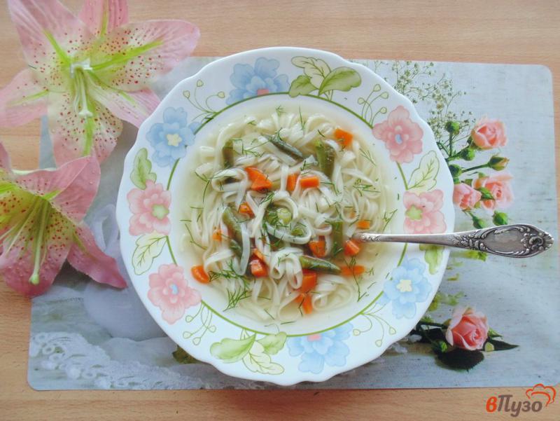 Фото приготовление рецепта: Куриный суп с лапшой удон и спаржевой фасолью шаг №7