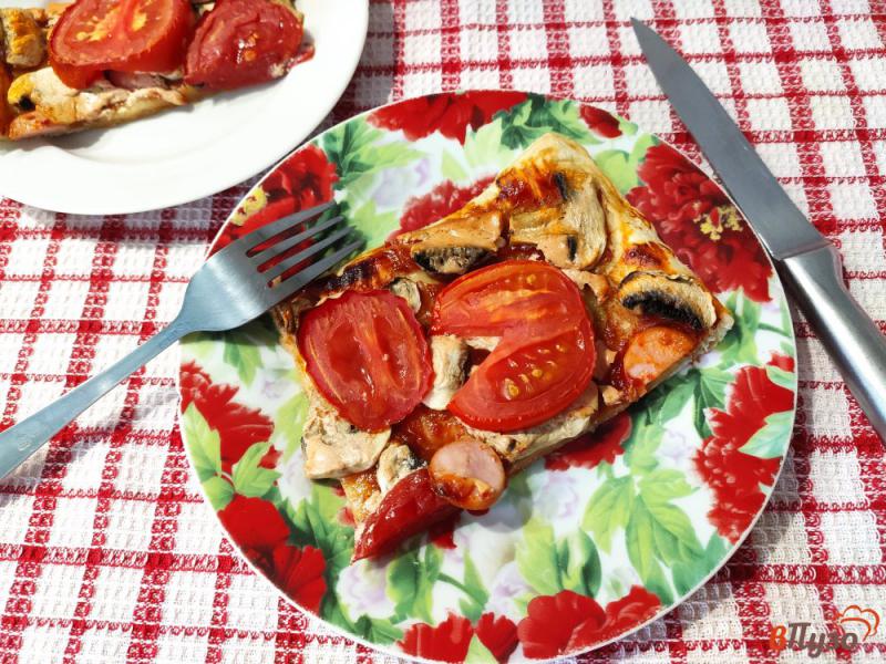 Фото приготовление рецепта: Пицца на слоеном тесте с шампиньонами помидорами и сосисками шаг №9