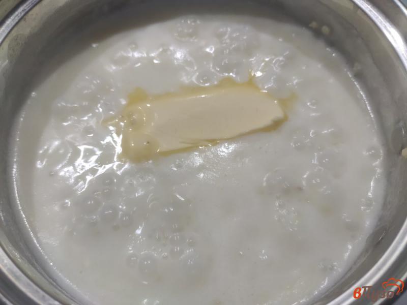 Фото приготовление рецепта: Пшенная молочная каша с изюмом шаг №6