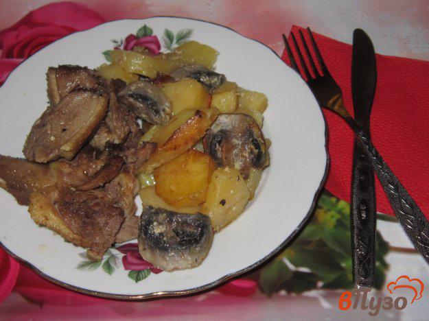 фото рецепта: Утка запеченная с картофелем и грибами в сметане